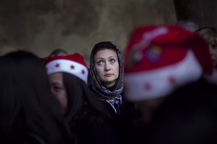 A Christian pilgrim lines up to go inside the Grotto, at the Church of Nativity, believed by many to be the birthplace of Jesus Christ, in the West Bank town of Bethlehem, Saturday, Dec. 24, 2011. (AP Photo/Bernat Armangue)